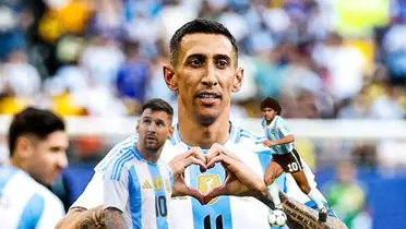 Angel Di Maria does his trademark celebration while Lionel Messi looks up and Diego Maradona dribbles with the ball.