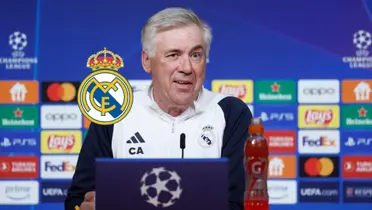Carlo Ancelotti looks confused as he is in a press conference for the Champions League and the club badge is next to him. (Source: RMadridFrance X)