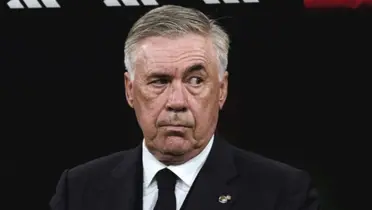Carlo Ancelotti looks serious while wearing the suit.