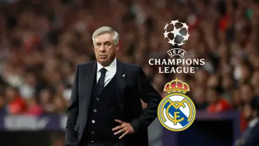 Carlo Ancelotti looks worried as his hand is on his hip; The Champions League logo and the Real Madrid logo are next to him.