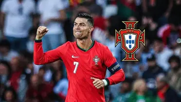 Cristiano Ronaldo is happy as he puts his fist in the air and wears the Portugal national team jersey; the Portugal national team badge.
