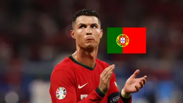 Cristiano Ronaldo looks upset as he wears the Portugal jersey and the Portugal flag is next to him. (Source: GOATTWORLD X)
