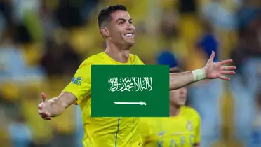 Cristiano Ronaldo opens his arms with a smile on his face while wearing the Al Nassr shirt.