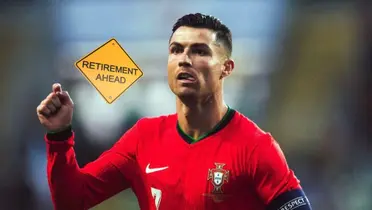 Cristiano Ronaldo points to the ground while wearing the Portugal national team jersey and the 'Retirement Ahead' sign is next to him.