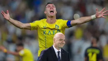 Cristiano Ronaldo screams with joy and with his arms out; the FIFA President, Gianni Infantino, smiles.