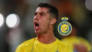 Cristiano Ronaldo screams with joy at the fans while wearing the Al Nassr jersey and the Al Nassr badge is next to him.