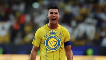 Cristiano Ronaldo screams with passion while wearing the Al Nassr jersey and the Al Nassr badge is in the middle.