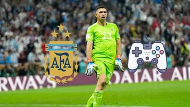 Emiliano Martinez celebrates with the goalkeeper Argentina kit while the Argentina badge and a video game controller is next to him.