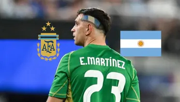 Emiliano Martinez looks to the side as the Argentina national team badge and the Argentina flag is next to him. (Source: AlbicelesteTalk X)