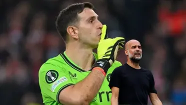 Emiliano Martinez shushes the crowd with his finger and Pep Guardiola makes an angry face.