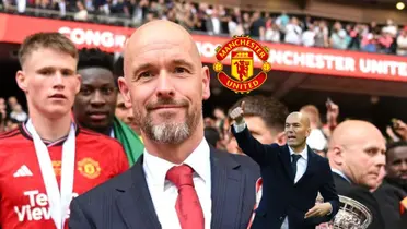 Erik Ten Hag smiles while holding the FA Cup trophy and the Manchester United badge is next to him; below him is Zinedine Zidane pointing.