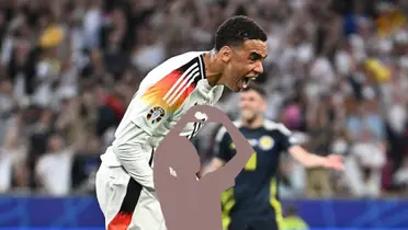Jamal Musiala celebrates a goal for Germany while a mystery player is below him. (Source: Jamal Musiala X)