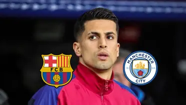 Joao Cancelo looks to his left while wearing an FC Barcelona jacket and the FC Barcelona and Man City badges are next to him. (Source: FC Barcelona X)