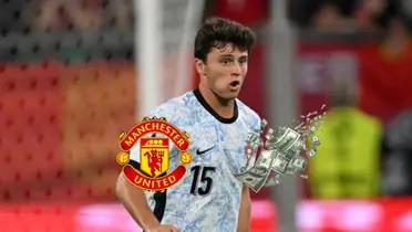 Joao Neves looks focused as he wears the away Portugal jersey at the EUROS; the Manchester United logo and money is below him. (Source: Getty Images)