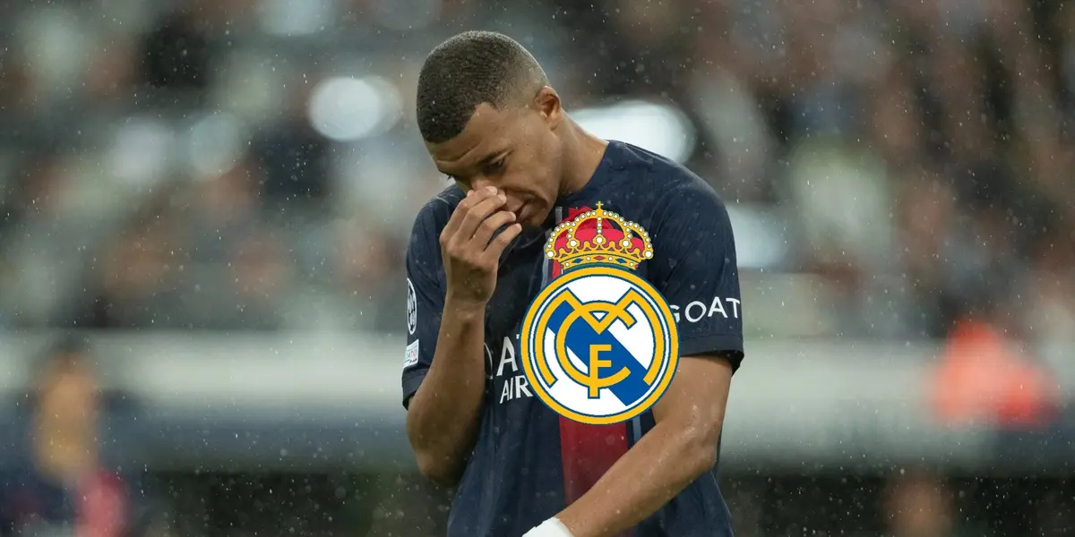 Kylian Mbappé has his hand on his nose and looks down while the Real Madrid badge is on him.