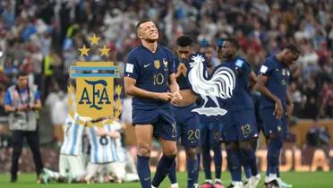 Kylian Mbappé looks upset while wearing the French national team jersey; the Argentina and France national team badges are next to him.