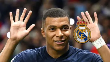 Kylian Mbappé puts his hands up while wearing a France kit and a Real Madrid logo is next to him.
