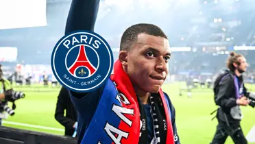 Kylian Mbappé wears a PSG scarf on while he looks at the crowd and the PSG badge is next to him.