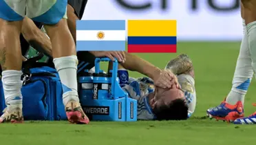 Lionel Messi cries on the pitch on the ground in pain in the Copa America final with the Argentina and Colombia flags above him. (Source: Messi Xtra X)