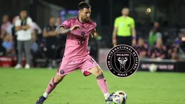 Lionel Messi dribbles the ball while wearing the Inter Miami jersey; the Inter Miami badge is next to him.