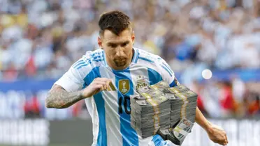 Lionel Messi looks down as he wears the Argentina national team jersey and a stack of cash is below him.