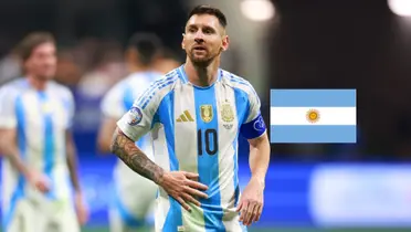 Lionel Messi looks tired while wearing the Argentina jersey and the Argentina flag is next to him. (Source: Getty Images)