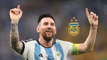Lionel Messi smiles and celebrates with the Argentina jersey on and the Argentina national team badge is next to him. (Source: Getty Images)