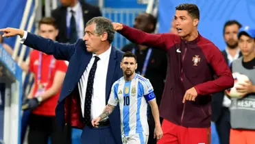 Lionel Messi walks with the Argentina jersey on while Cristiano Ronaldo tells instructions to the Portugal players next to his coach in the EURO 2016 Final. (Source: Sports Illustrated) 