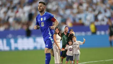 Lionel Messi wears the dark blue Argentina jersey while a picture of Messi and his family is below him.
