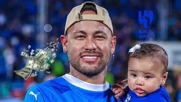 Neymar Jr. smiles while carrying her daughter with money flying next to him and an Al Hilal logo is on the top right.