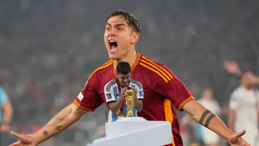 Paulo Dybala celebrates a goal with AS Roma while he also looks at the World Cup while wearing the Argentina jersey. (Source: Associated Press, Getty Images)