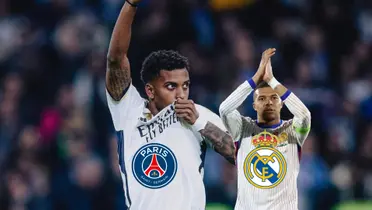 Rodrygo kisses the Real Madrid crest while Kylian Mbappé claps while wearing the France jersey; the PSG and Real Madrid badges are below them. (Source: Fabrizio Romano X, Getty Images)