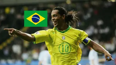 Ronaldinho smiles and points while wearing the Brazil jersey; the Brazil flag is next to him.