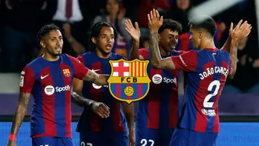 The FC Barcelona players celebrate together after a goal is scored and the FC Barcelona badge is in the middle.