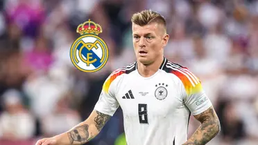 Toni Kroos looks at the pitch while wearing the Germany jersey in EURO 2024; the Real Madrid badge is next to him.