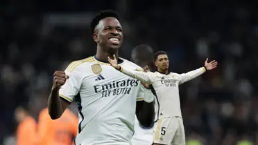 Vinicius Jr smiles while showing the Real Madrid badge on his jersey and Jude Bellingham does his trademark celebration while wearing the Real Madrid jersey.
