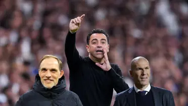 Xavi Hernandez gives instructions to his players while Thomas Tuchel smiles and Zinedine Zidane looks confused.