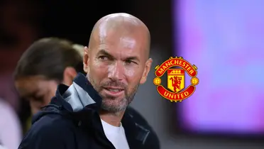 Zinedine Zidane looks to his right while the Manchester United logo is next to him.