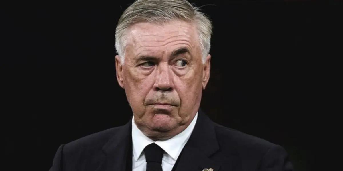 Carlo Ancelotti looks serious while wearing the suit.