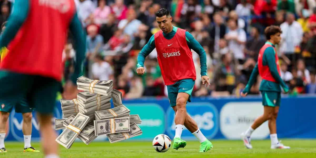 Cristiano Ronaldo dribbles with the ball while training with Portugal; a stack of cash is next to him.