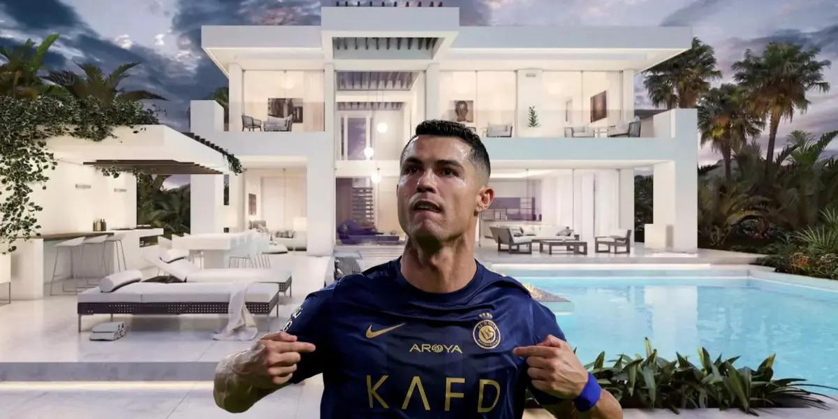 Cristiano Ronaldo points at himself while wearing the Al Nassr jersey and a mansion is behind him.