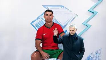 Cristiano Ronaldo poses for a picture wearing the new Portugal home kit while Jose Mourinho waves.
