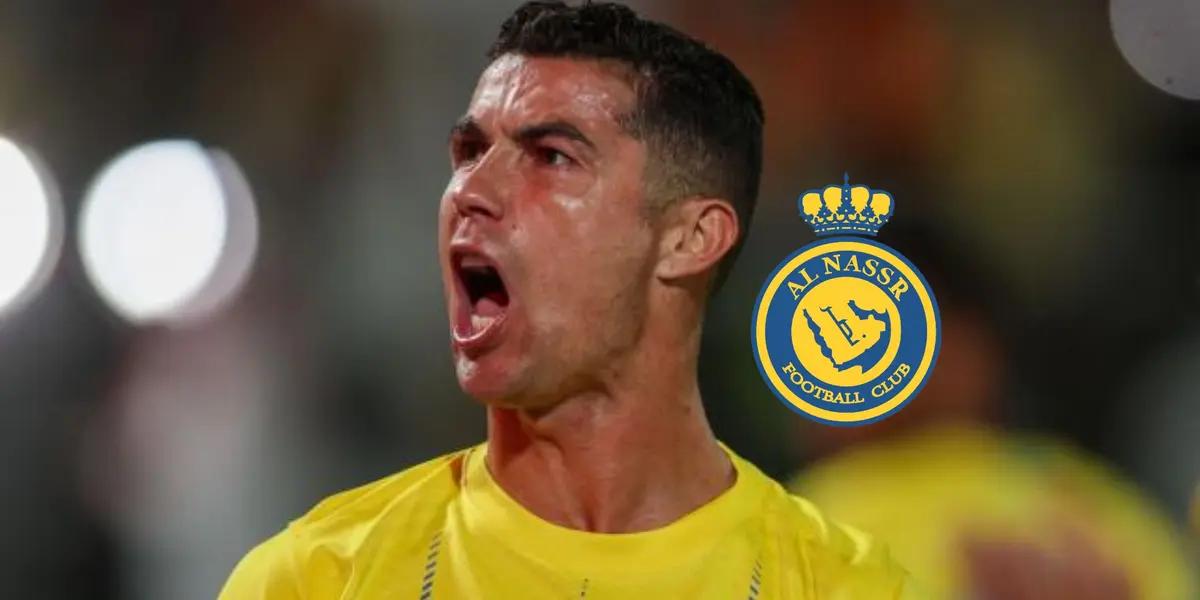 Cristiano Ronaldo screams with joy at the fans while wearing the Al Nassr jersey and the Al Nassr badge is next to him.