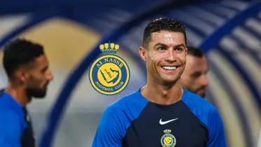Cristiano Ronaldo smiles as he wears an Al Nass training shirt with an Al Nassr logo next to him.