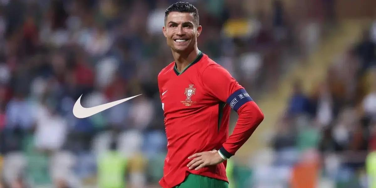 Cristiano Ronaldo smiles while wearing the Portugal jersey and the Nike logo is next to him.