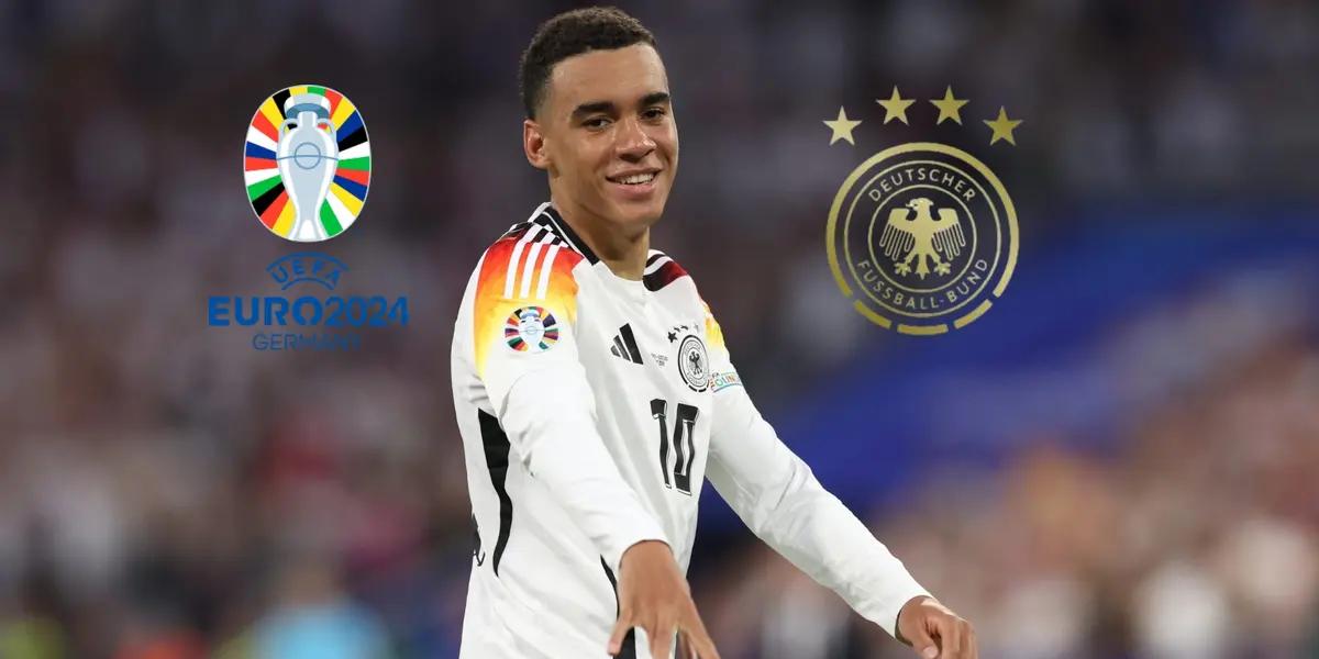 Jamal Musiala does his trademark celebration while the EURO 2024 logo and the German national team badge is next to him. (Source: Get German Football News)