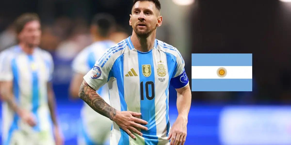 Lionel Messi looks tired while wearing the Argentina jersey and the Argentina flag is next to him. (Source: Getty Images)