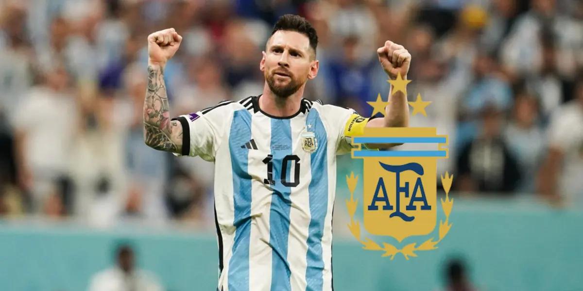 Lionel Messi puts his fists in the air while wearing the Argentina national team as the Argentina national team badge is next to him.