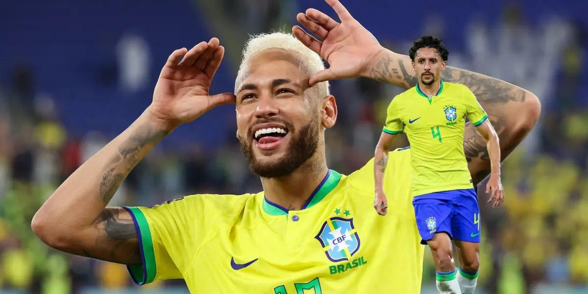 Neymar does a celebration with his hands wearing the Brazil kit while Marquinhos also wears the Brazil kit.