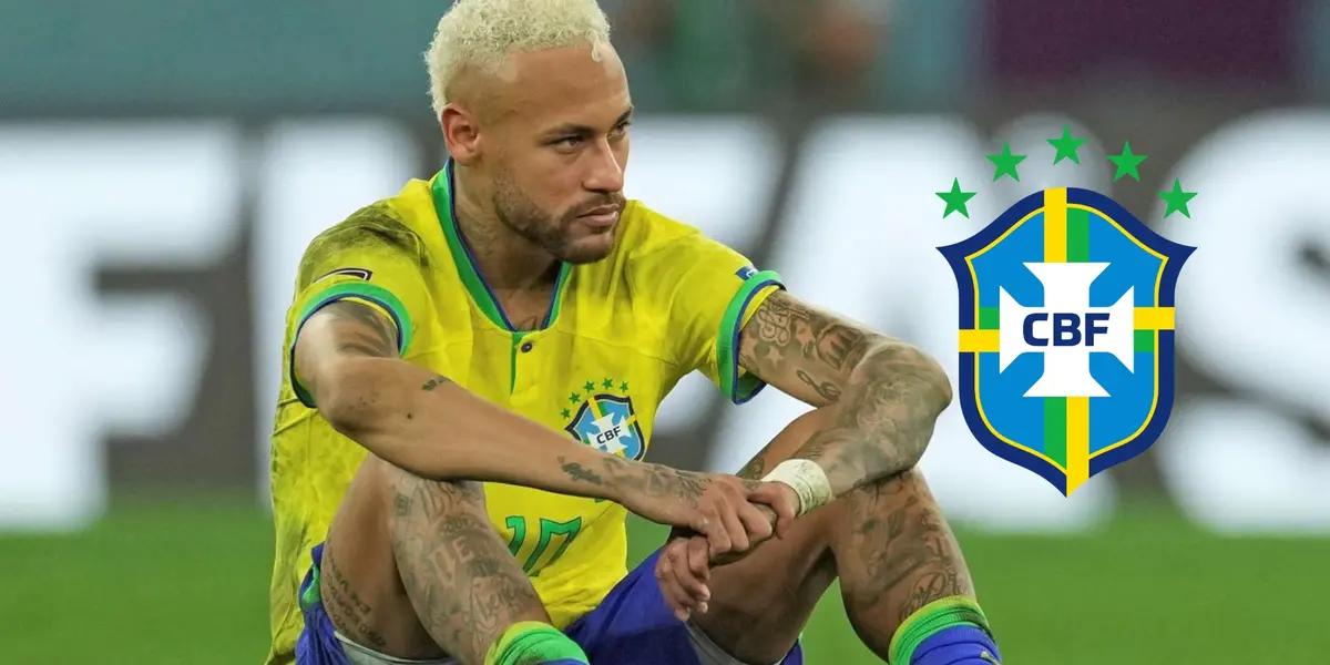 Neymar Jr. sits on the ground upset while wearing the Brazil national team kit; the Brazil national team badge is next to him.